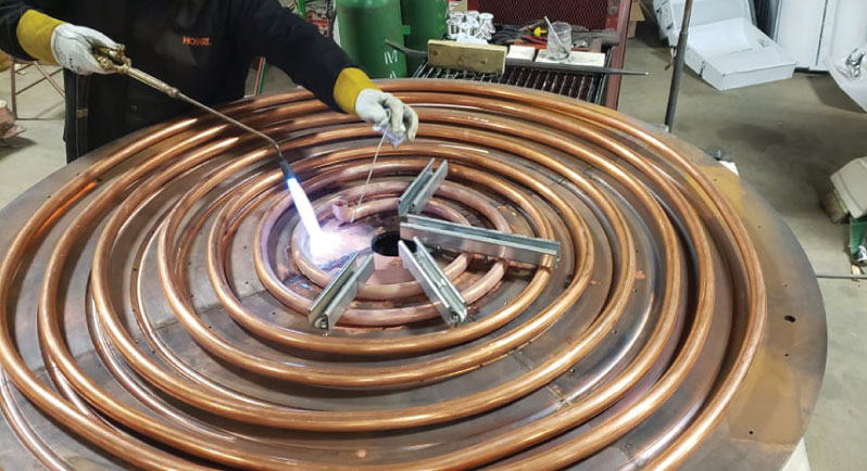 Cooling coil being brazed to its base for our largest induction furnace